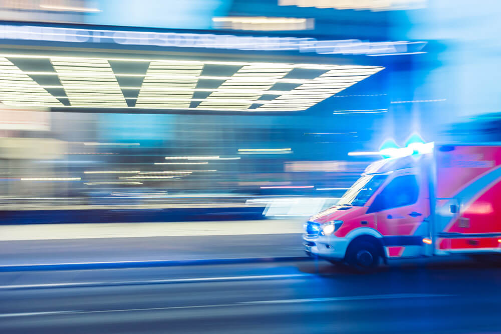 Blurred moving ambulance outside hospital