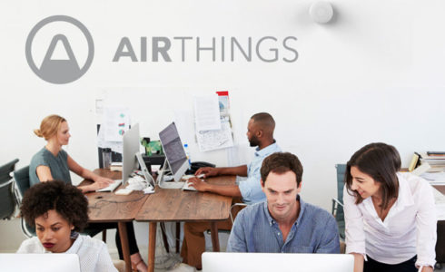 Office with Airthings logo and wave plus product on the back wall